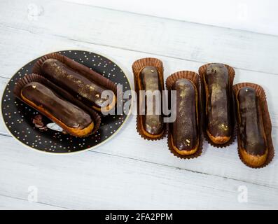 Gorgeous extra chocolate eclairs with gilded glaze Stock Photo