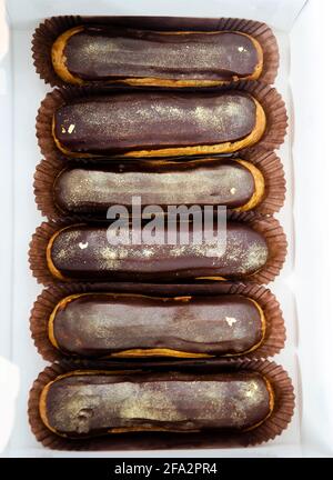 Gorgeous extra chocolate eclairs with gilded glaze Stock Photo