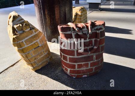Unusual brick suitcases in the summer sun on a railway platform. Amsterdam. Stock Photo