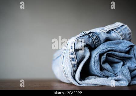Folded blue jeans on the table Stock Photo