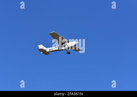 A Cessna C172S G-LLCH light aircraft in the skies over Lulsgate, Bristol Airport with a beautiful blue sky background Stock Photo