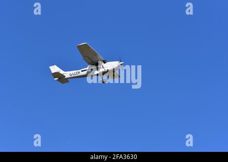 A Cessna C172S G-LLCH light aircraft in the skies over Lulsgate, Bristol Airport with a beautiful blue sky background Stock Photo