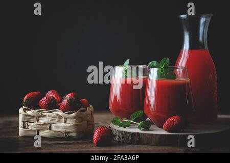 Close up view of two glasses of homemade refreshing strawberries juice nectar drink and mint Stock Photo