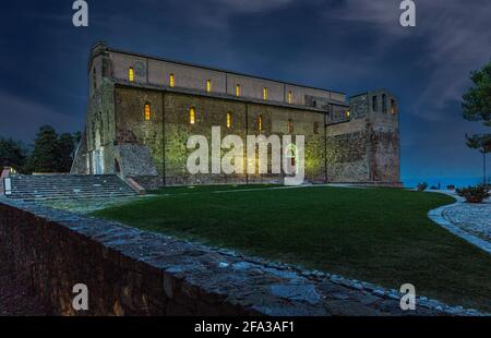 Night panorama of the Abbey of San Giovanni in Venere illuminated by artificial lights. Fossacesia, Chieti Province, Abruzzo, Italy, europe Stock Photo