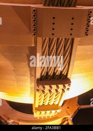 A detail of the big gold painted steel plate sway damper cables. In Taipei, Taiwan. Stock Photo