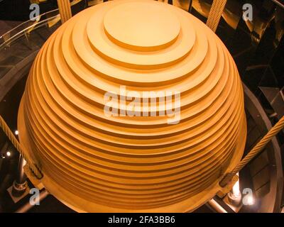 Looking down at the big gold painted steel plate sway damper. In Taipei, Taiwan. Stock Photo