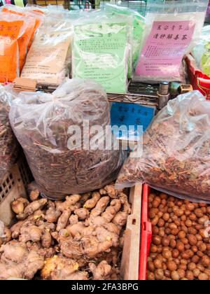 Ginger, bags of dried leaves and other foods, medicine ingredients. At old Spice Alley in Taipei, Taiwan. Stock Photo