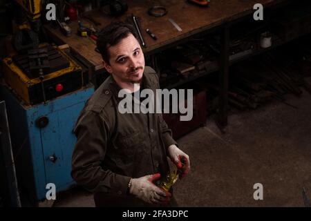 Traditional metalworking process in a forge. Portrait of a working man Stock Photo