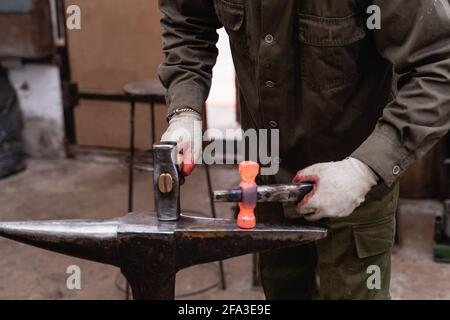 Traditional metalworking process in a forge. Close-up of processing a workpiece using traditional forging. Stock Photo