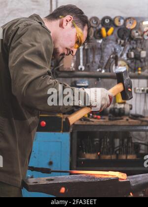 Traditional metalworking process in a forge. Close-up of processing a ...
