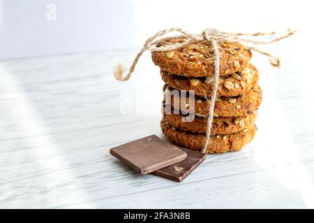 Oatmeal cookies in a stack tied by a thread. close-up. Diet product. Cereal food Stock Photo