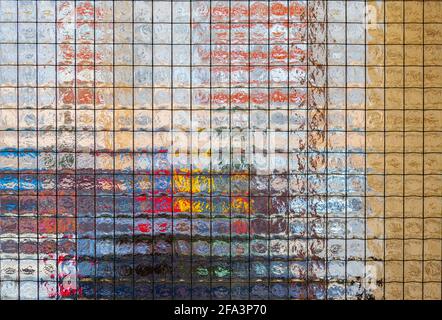 Close up a black grid metal fence of a glass window and blur outside. Wired glass of the door Stock Photo