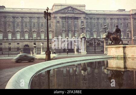 Buckingham Palace, mirrored in the basin of the Victoria Memorial, London, England, UK, 1964 Stock Photo