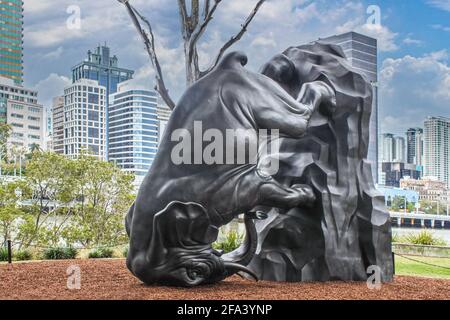 July 8 2017 Brisbane Australia Upside down elephant - The World Turns -statue by river in Central Business District with urban skyline in background Stock Photo