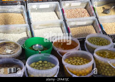 Several different types of olives in translucid cups at the street market Stock Photo
