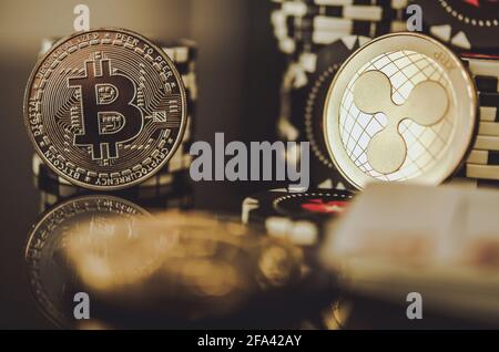 BTC Bitcoin and XRP Ripple Coins Between Casino Chips. Entertainment and Modern Blockchain Payments Concept. Stock Photo