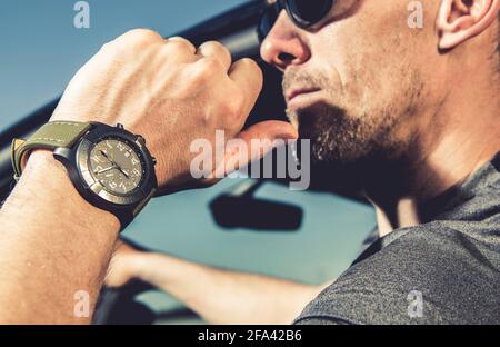 Military Style Luxury Hand Watch Timepiece on Caucasian Men Hand Close Up. Stock Photo
