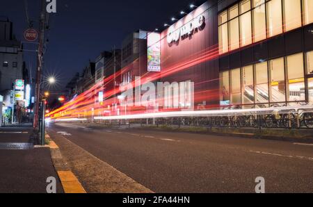 Tokyo, Japan - October 20 2020: Long-exposure capture of light trails made by passing cars on street in western Tokyo Stock Photo