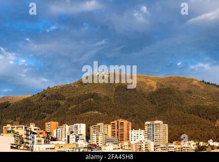 Modern apartment buildings by Pichincha volcano at sunrise, Quito, Pichincha province, Ecuador. Stock Photo