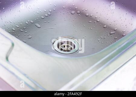 Metal empty sink in the kitchen. Housework, washing dishes, household duties concept. Stock Photo