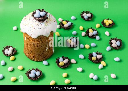 Easter Cakes or Paska and eggs composition on green background. Stock Photo