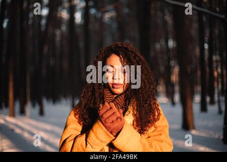 Portrait of beautiful young woman standing in park during cold winter Stock Photo