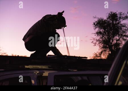 Rigging Overlanding Setup Before Sunrise in African Wilderness Stock Photo