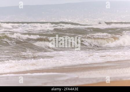 Storm at sea. High waves lift tons of sand from the bottom. Whitecaps and the rolling sea. Stock Photo