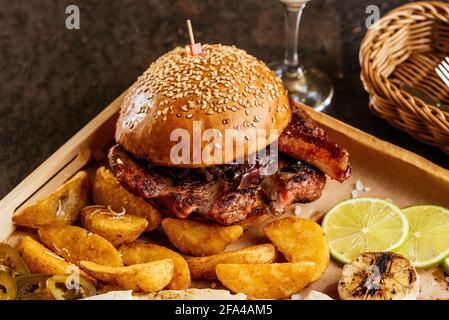 american burger with potatoes, sauce, snacks Stock Photo