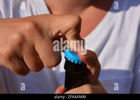 Woman opening a bottle, close up of hands Stock Photo