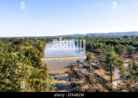 Weir on Nepean river with impact after floods - fallen trees in view of Bridges, Penrigh and Emu plains of Greater Sydney. Stock Photo