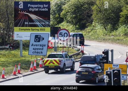 Langley, UK. 22nd April, 2021. Traffic passes a sign announcing works by Highways England to convert the M4 into a 'smart motorway' close to Junction 5. The government has announced that all future 'all lane running' motorways, including any such as the M4 currently being constructed, will require radar technology to detect stopped cars. Credit: Mark Kerrison/Alamy Live News Stock Photo