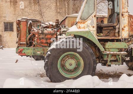 old rusty abandoned tractors in snowy winter Stock Photo