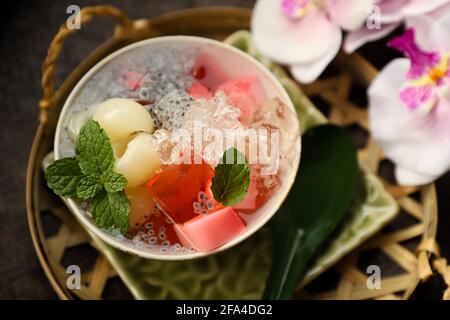 Iced Longan Jelly. Preserved longan fruit in syrup with red jelly, milk agar agar and crushed ice Stock Photo