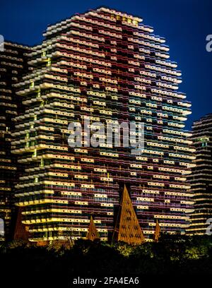 Sanya China , 25 March 2021 : Vertical view of one of the building of Beauty Crown Grand Tree hotel illuminated at night in Sanya city Hainan island C Stock Photo