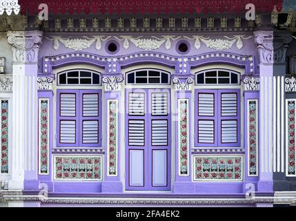 Colorful traditional Peranakan shophouse with lilac and white exterior and ornate tiles in historic Joo Chiat, Katong Singapore Stock Photo