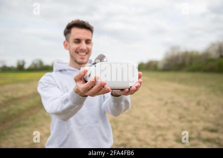 Close-up of the Oculus Quest 2 virtual reality headsets held in the hand by a boy Stock Photo