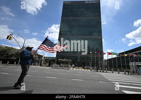 New York, USA. 22nd Apr, 2021. A man stands in front of the United Nations Headquarters waving an U.S. flag while participating in a protest, New York, NY, April 22, 2021. The United Nations currently holds most of its meeting virtually, though the 76th session of the UN General Assembly is set to open on September 14, 2021 without any further details on who will attend in person. (Photo by Anthony Behar/Sipa USA) Credit: Sipa USA/Alamy Live News Stock Photo