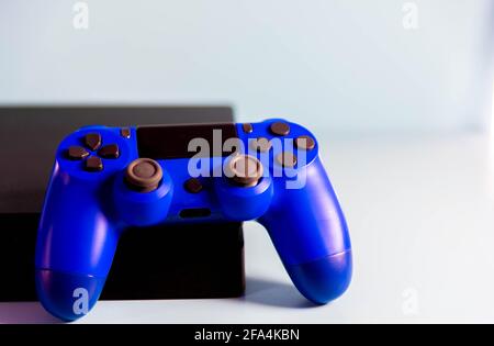 Controls and video game console on light background. Electronic game accessories. Video game gaming platform. Wish item for gamers. Modern, wireless g Stock Photo