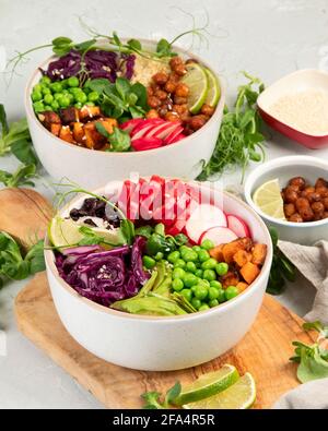 Tasty colorful vegan poke bowl on light gray background. Fresh healthy ...