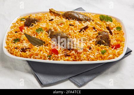 Indian or Pakistani food. mutton Biryani rice biriany with mint herb and naan bread on green background. Stock Photo
