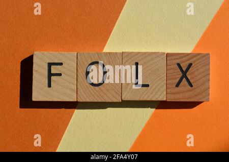 Folx, word in wooden alphabet letters isolated on orange background Stock Photo