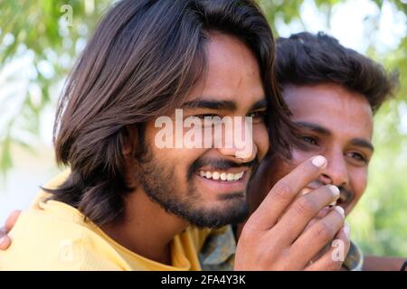 Portrait of an excited Indian gay couple embracing and smiling in a