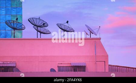 Satellite receiver on the building at the time of the twilight sky Stock Photo