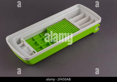 https://l450v.alamy.com/450v/2fa50ab/manual-vegetable-cutter-on-a-gray-background-white-green-special-plastic-cover-for-the-kitchen-chopper-of-vegetables-fruits-eggs-cheese-and-meat-2fa50ab.jpg