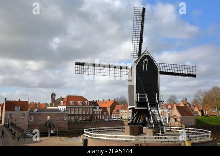 The old Harbor of Heusden, North Brabant, Netherlands, a fortified city located 19km far from Hertogenbosch, with a windmill in the foreground Stock Photo