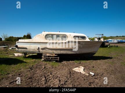 Dirty old motor boat in a salvage yard Stock Photo