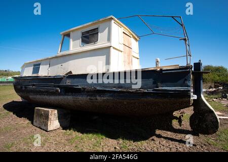 Old sea boat in a salvage yard Stock Photo