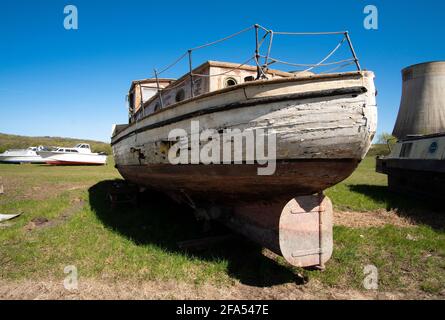 Old sea boat in a salvage yard Stock Photo