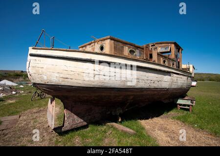 Old sea boat in a salvage yard Stock Photo